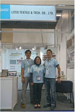 Three LiTex staff in matching branded polo shirts standing in an exhibition stand, beneath a sign reading LITEX TEXTILE & TECH. CO., LTD.